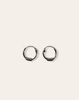 A pair of small silver hoop earrings with textured, ribbed detailing along the lower half, displayed on a solid off-white background.